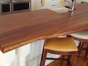 Zebrawood flat grain wood kitchen countertop, large double roman ogee edge profile, custom tung oil blend finish. Designed by Probuild Kitchen and Bath. Installled on Lake Norman in Cornelius, NC.