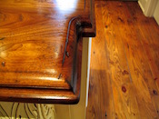 Distressed Walnut countertop edge detail close up. Large double roman ogee edge. Waterlox finish. Custom wood countertop installed in Charlotte, NC.