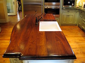 Distressed walnut countertop with undermount sink , wide plank walnut , 2” thick, large double roman ogee edge, waterlox finish. Installed in the Southpark area of Charlotte, NC.